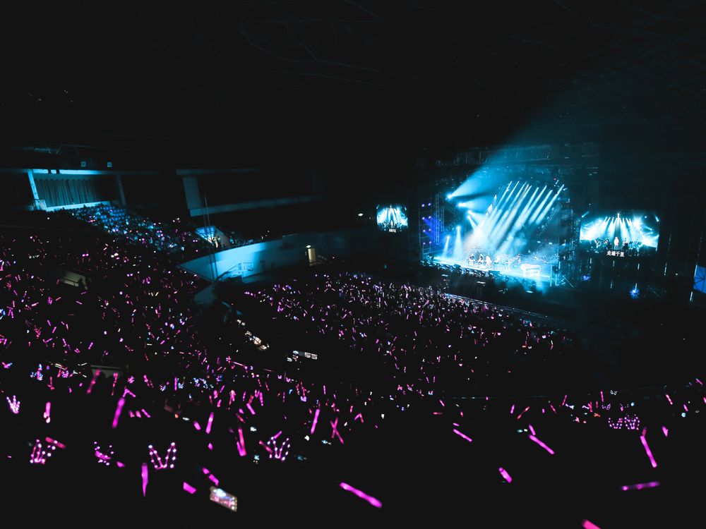 推しデビュ―～My Idol, My Debut～をLeminoで視聴するイメージ（K-POPライブのペンライトの海）
